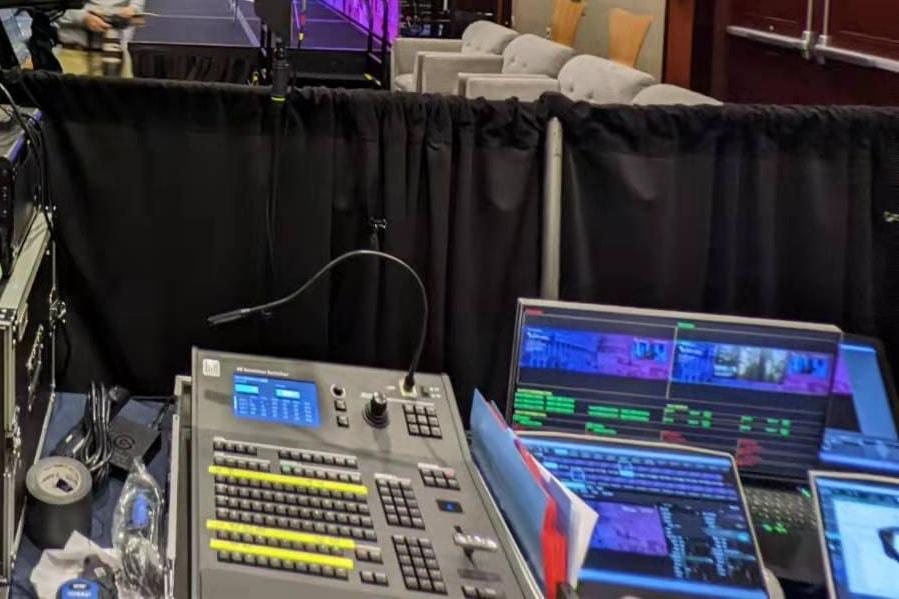 A 4K event switcher and a multiviewer screen at front of house, facing the stage