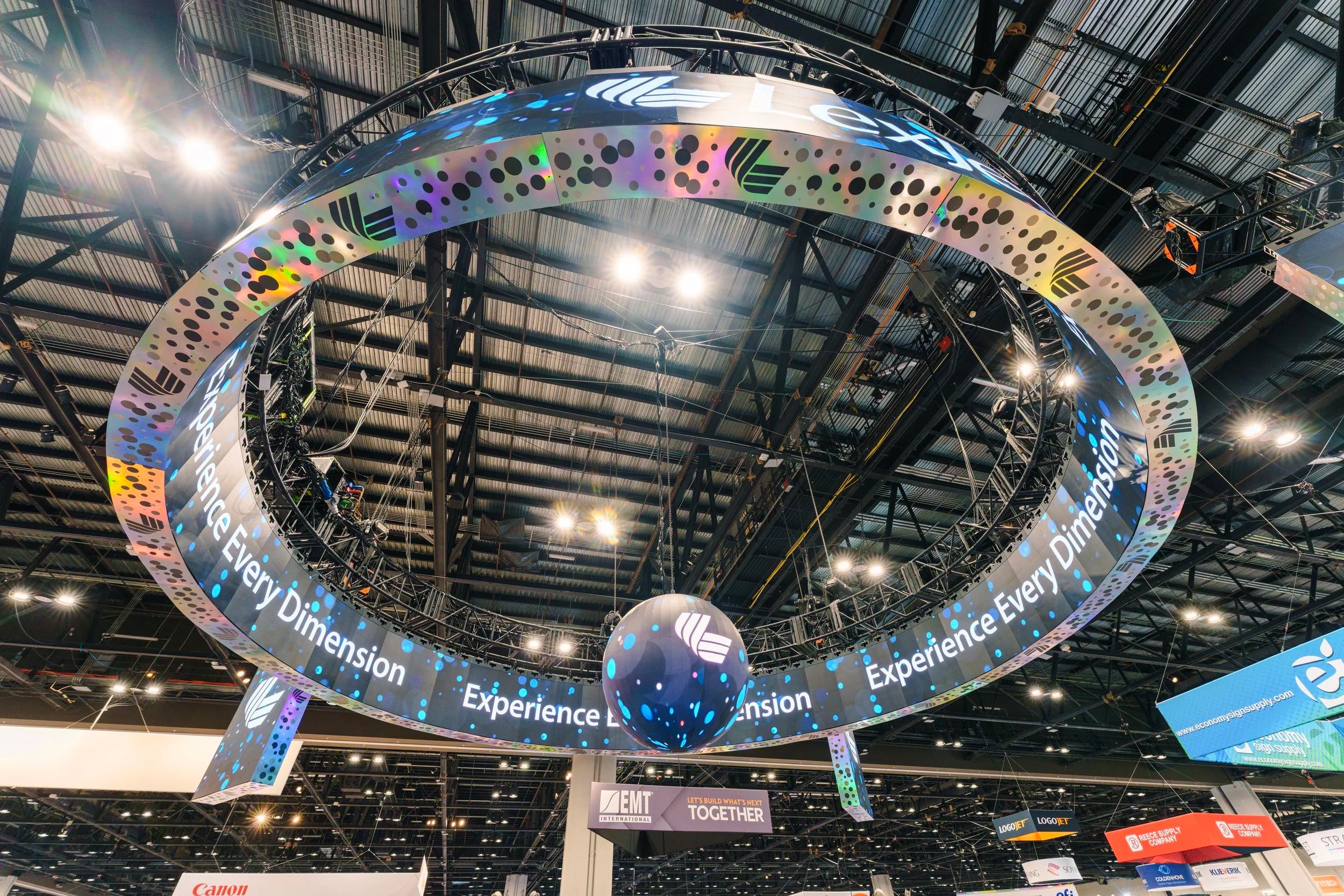 A crewed LED wall running live on a trade show floor
