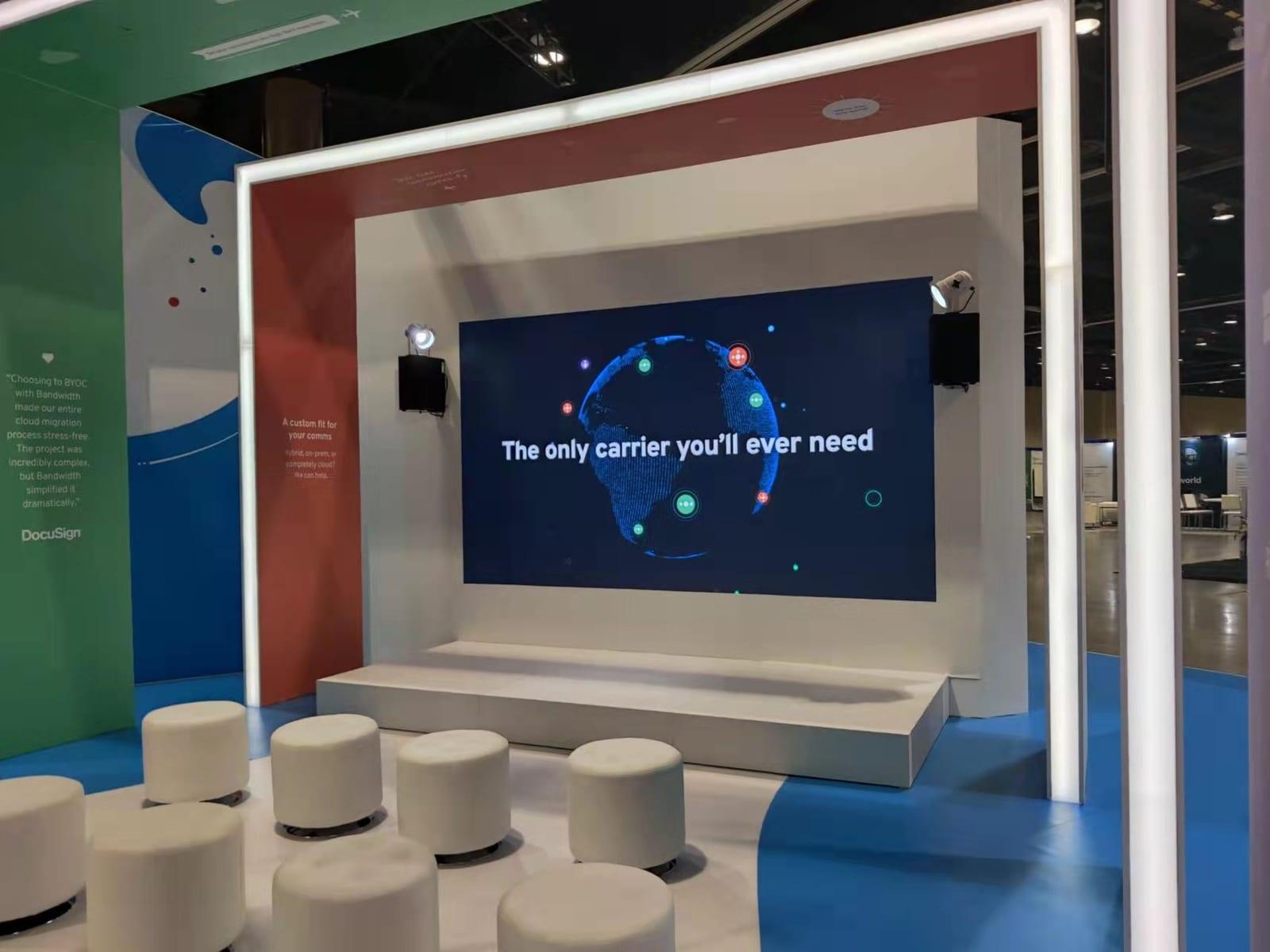 LED presentation wall above a small stage in the Bandwidth booth at Enterprise Connect 2022, Gaylord Palms, Kissimmee