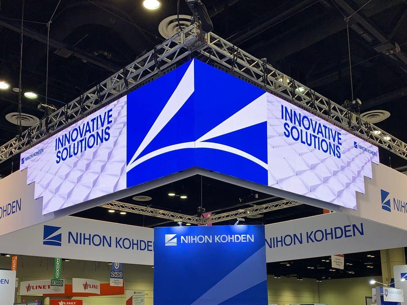 Hanging LED display wrapping a 90-degree corner above the Nihon Kohden booth at AACN NTI 2019, Orange County Convention Center, Orlando