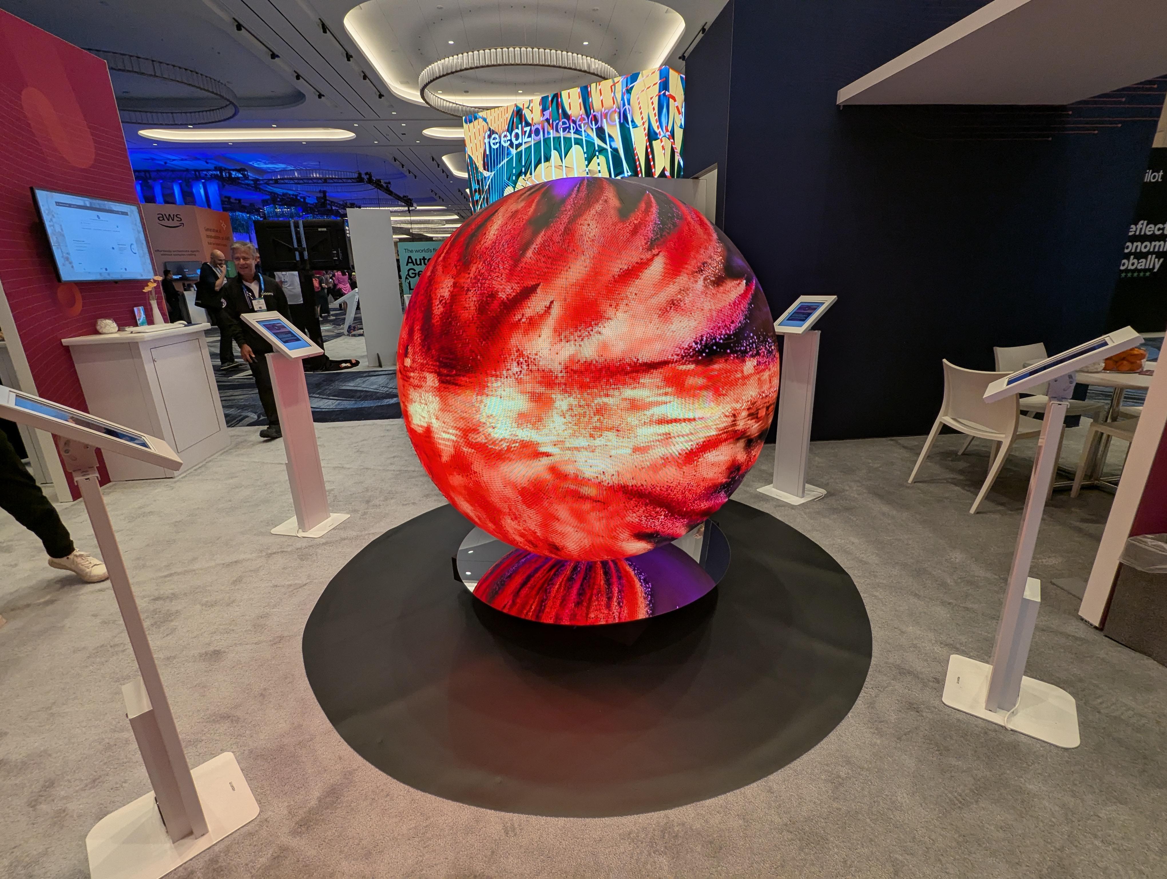 LED sphere playing content the whole way around as a booth centerpiece