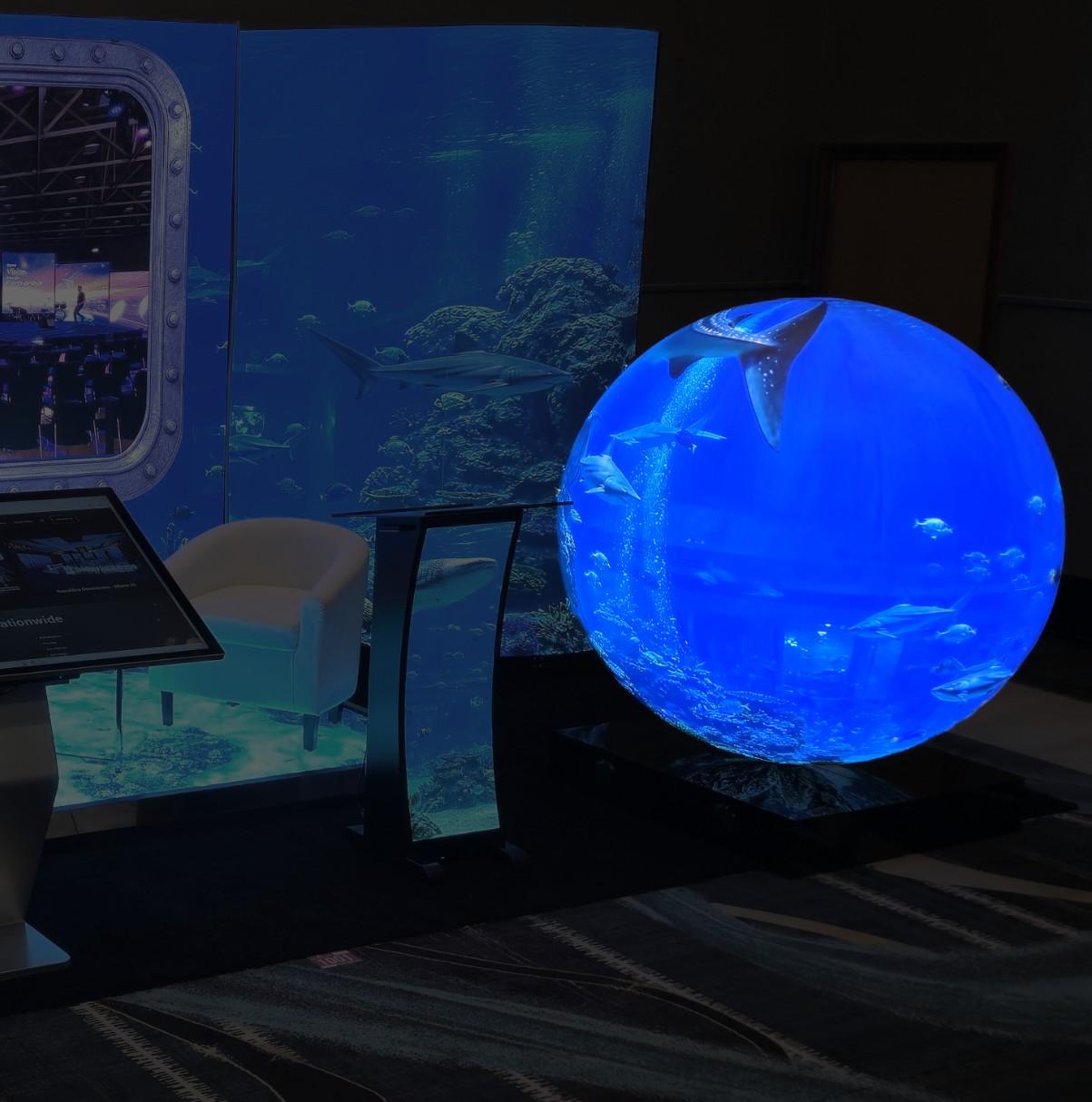 LED sphere running content as a booth centerpiece on the show floor